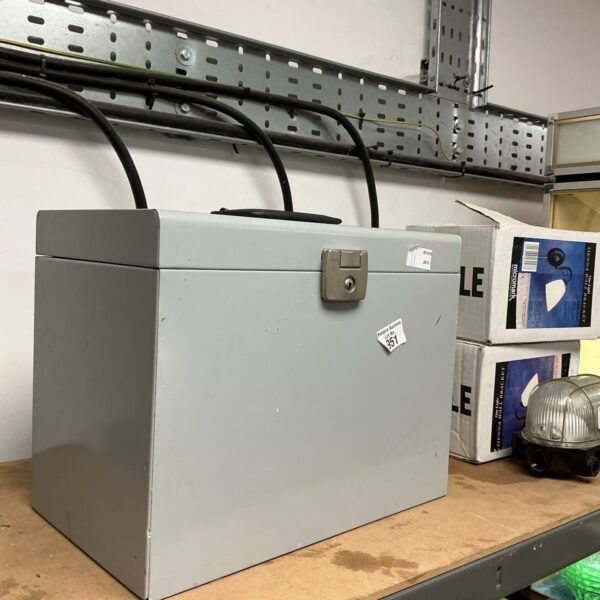 Vintage metal filing cabinet with locking mechanism for secure document storage.