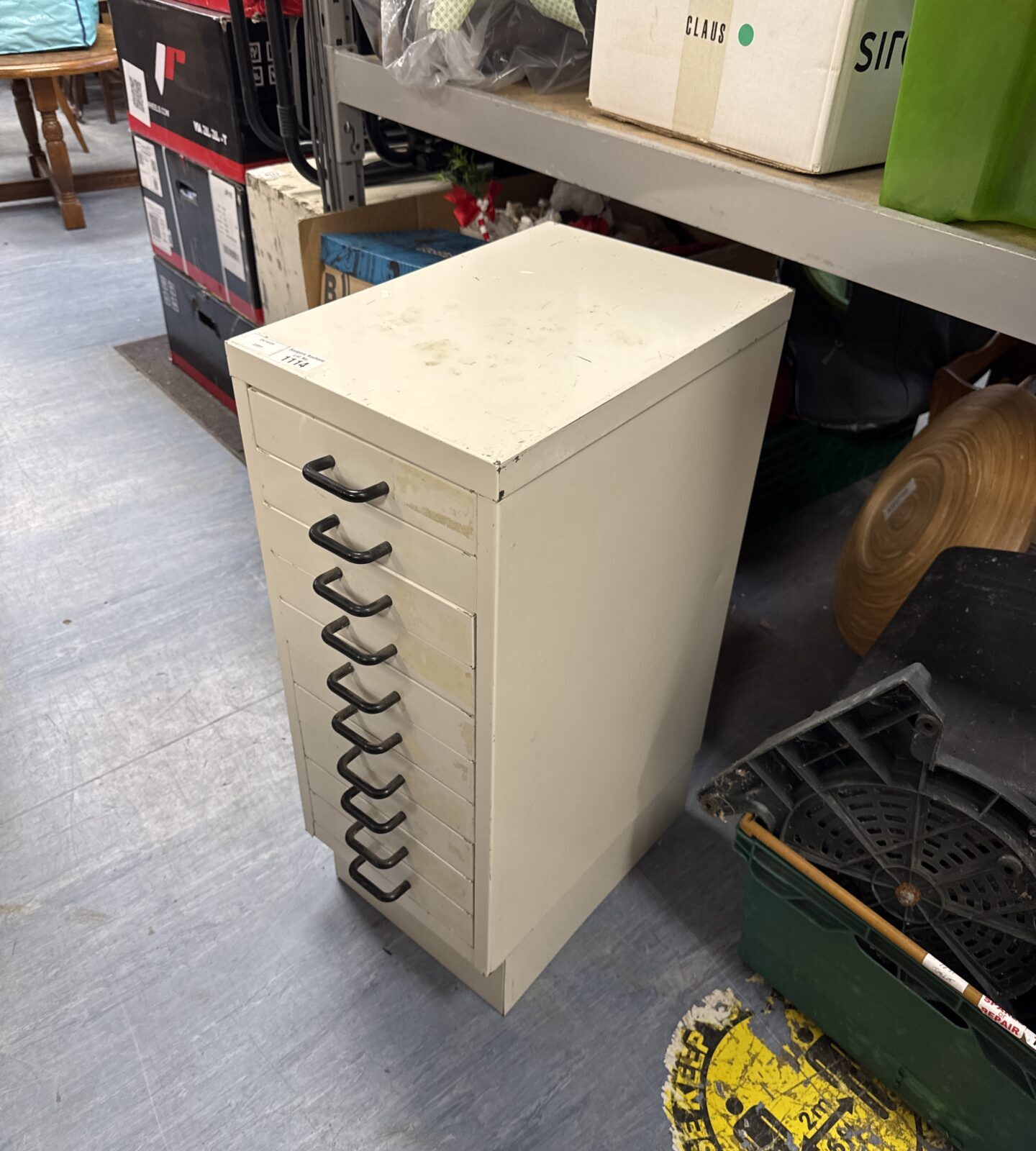 Vintage metal filing cabinet with a single drawer for office storage.