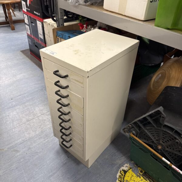 Vintage metal filing cabinet with a single drawer for office storage.