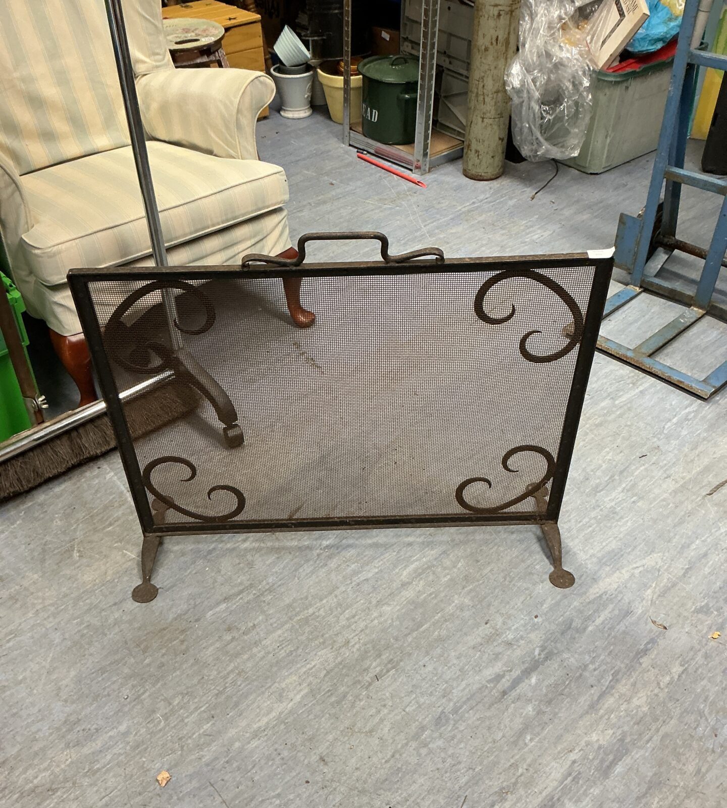 Vintage metal fire guard with decorative pierced design.