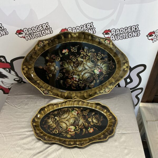 Ornate vintage metal trays with detailed floral designs.