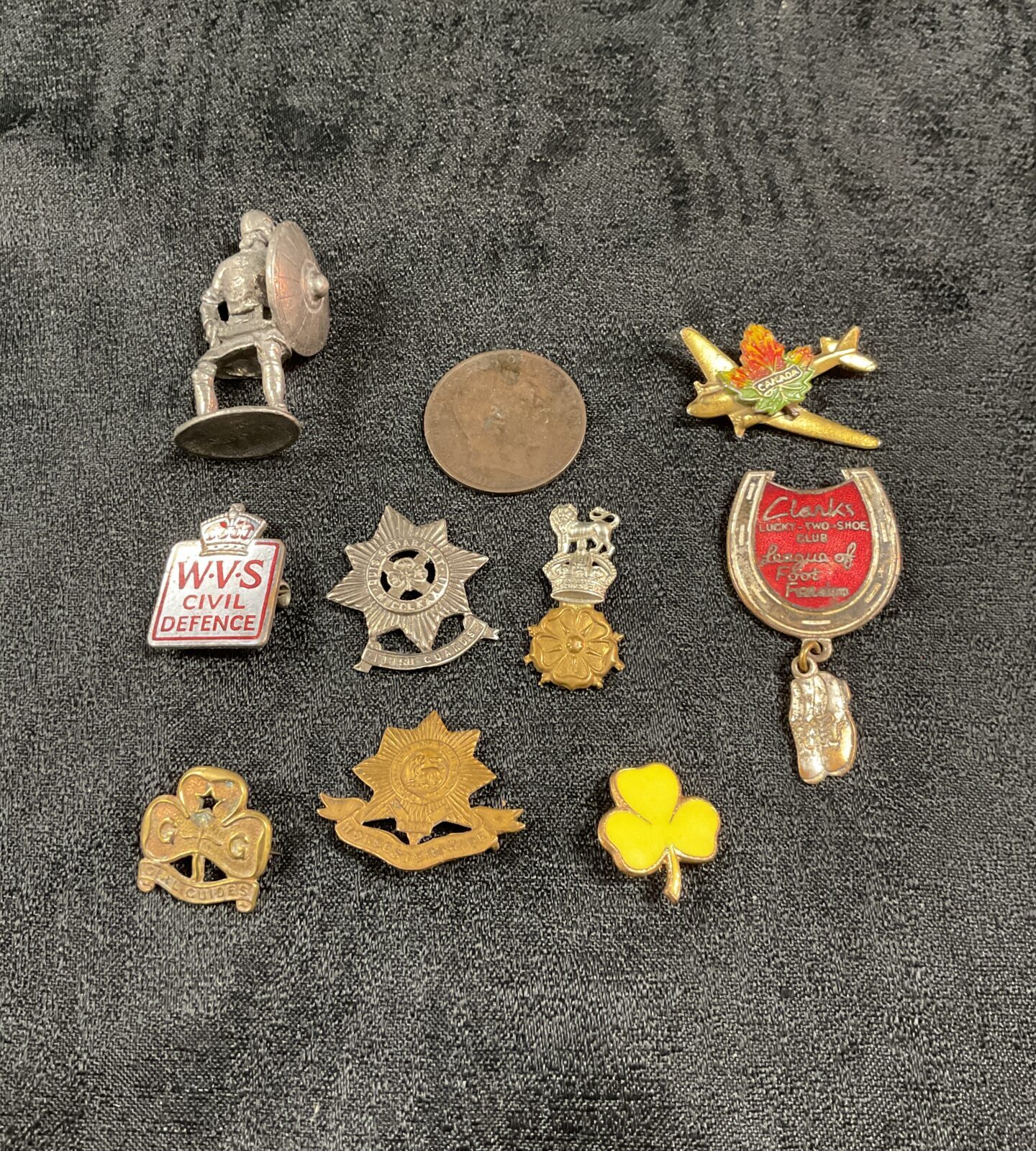Vintage collection of British military badges and insignia.