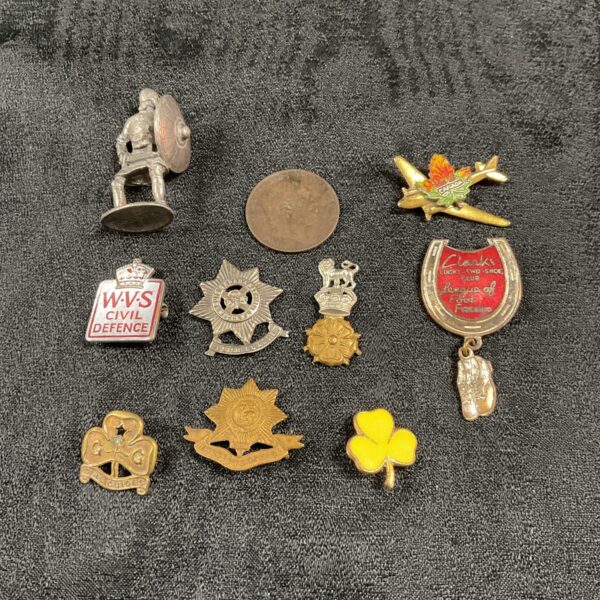 Vintage collection of British military badges and insignia.