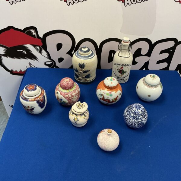 Vintage miniature ginger jar collection with floral designs.