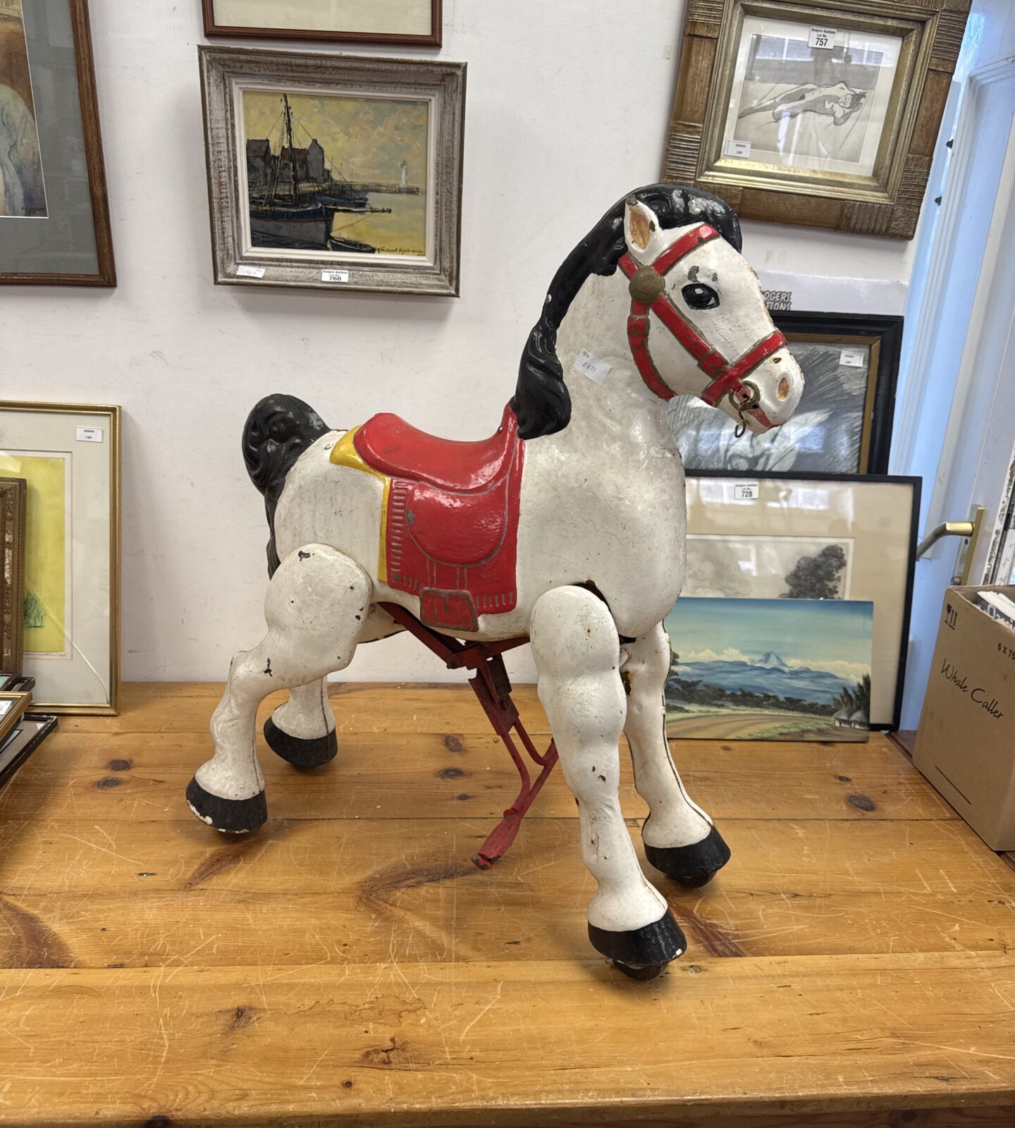 Full view of a vintage metal Mobo ride-on horse.