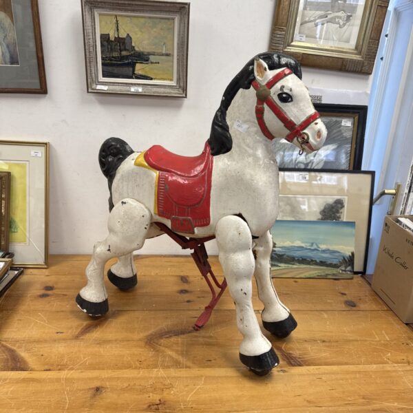 Full view of a vintage metal Mobo ride-on horse.