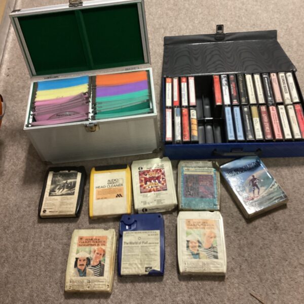 Vintage carrying case filled with cassette and eight-track tapes.