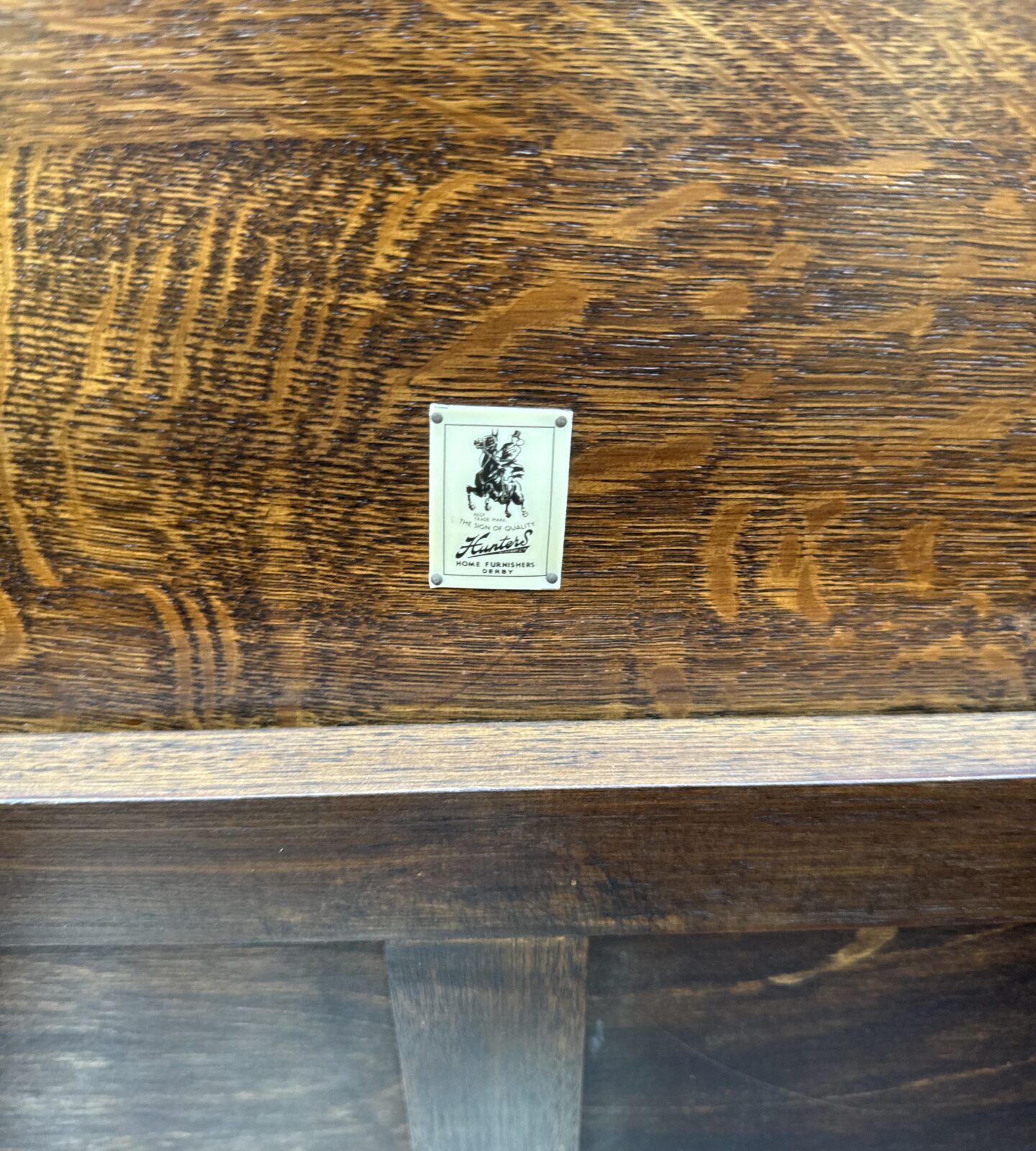 Close-up of the detailed paneling on a vintage oak chest.