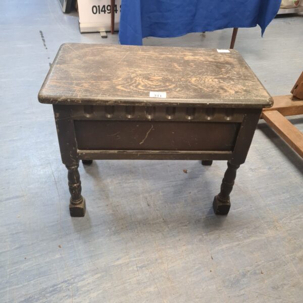 Front view of a vintage oak sewing table with lift-top.