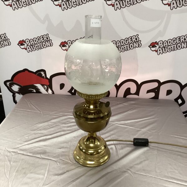 Vintage oil lamp repurposed as a table lamp with brass base.