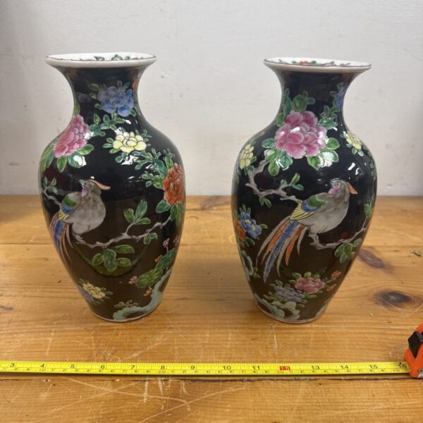Pair of vintage oriental vases with colourful bird designs.
