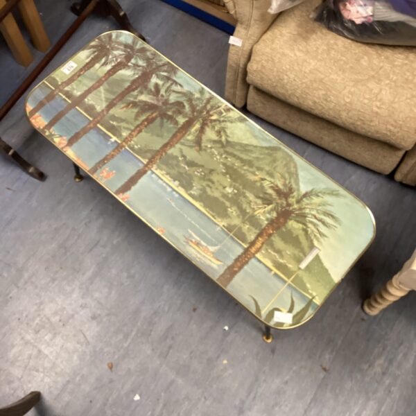 Vintage palm tree table with a vibrant tropical design.