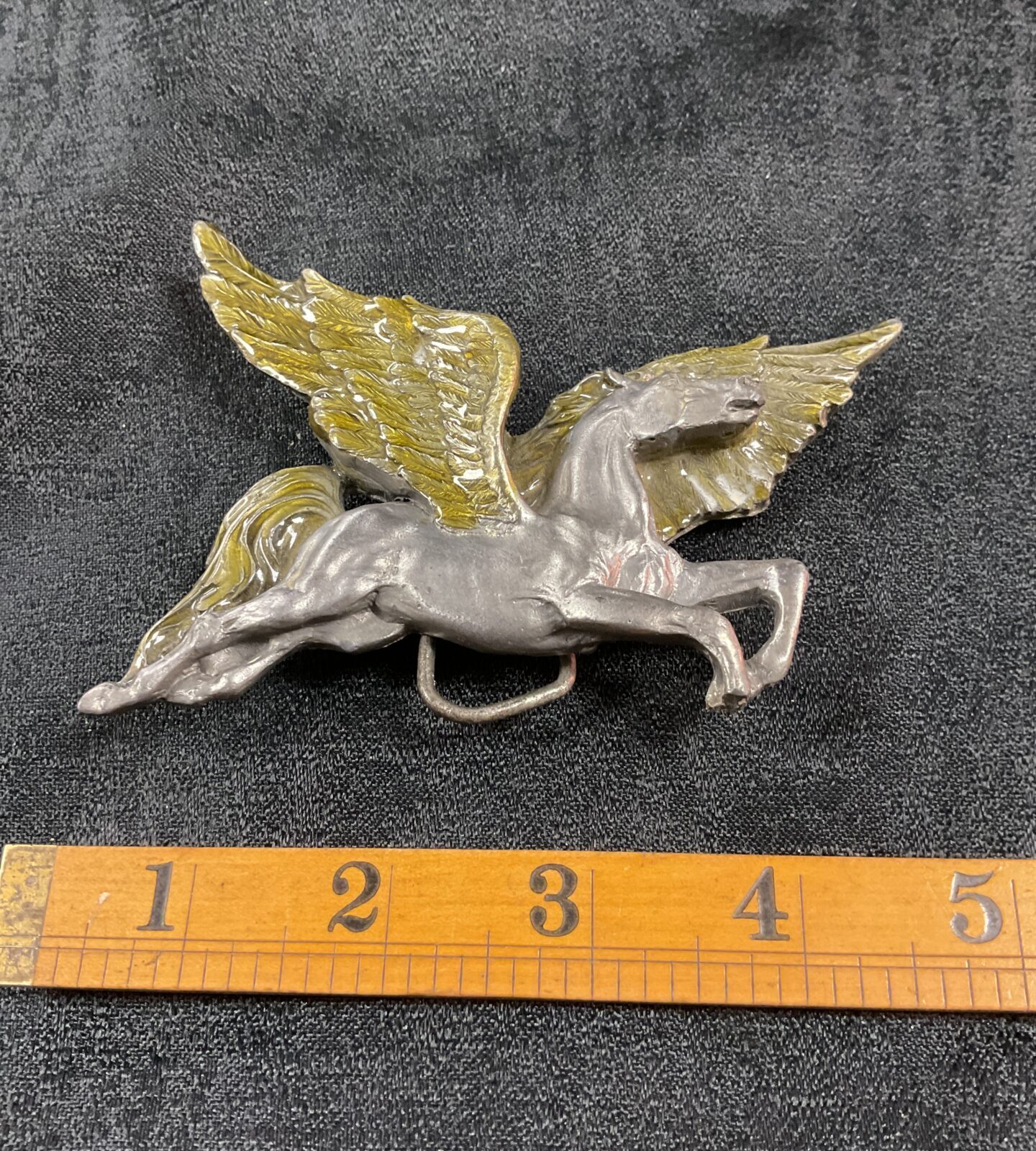 Detailed vintage Pegasus belt buckle, equestrian collectible.