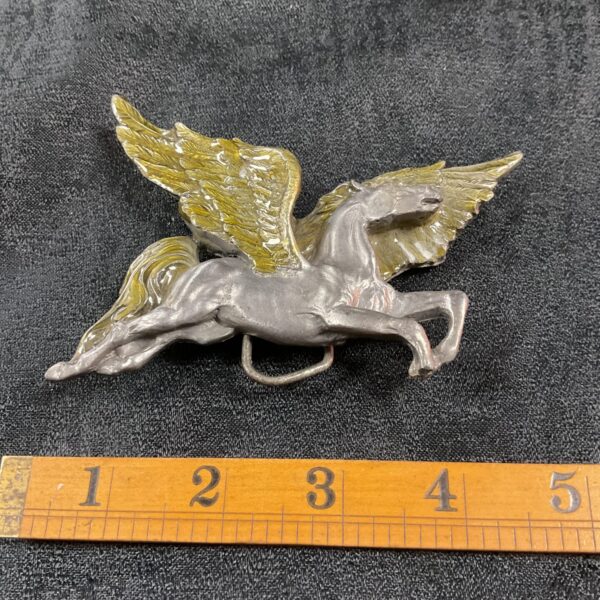 Detailed vintage Pegasus belt buckle, equestrian collectible.
