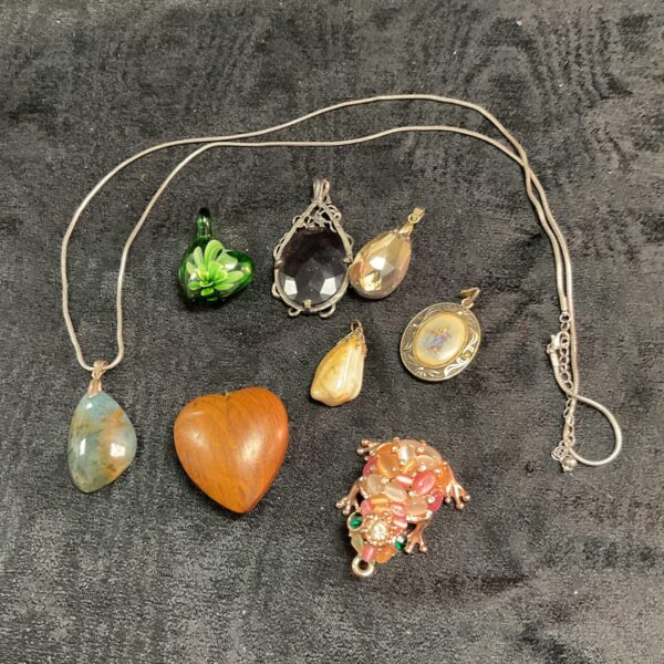 Vintage pendant necklace with eclectic assortment of pendants.