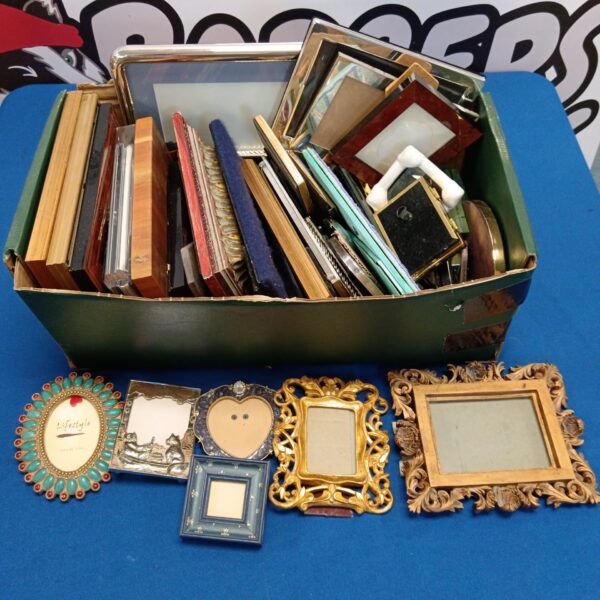 Large lot of assorted vintage photo frames with silver accents.
