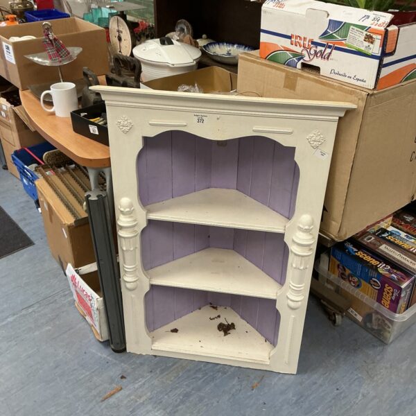 Vintage pine corner unit with three shelves, painted in a light colour.