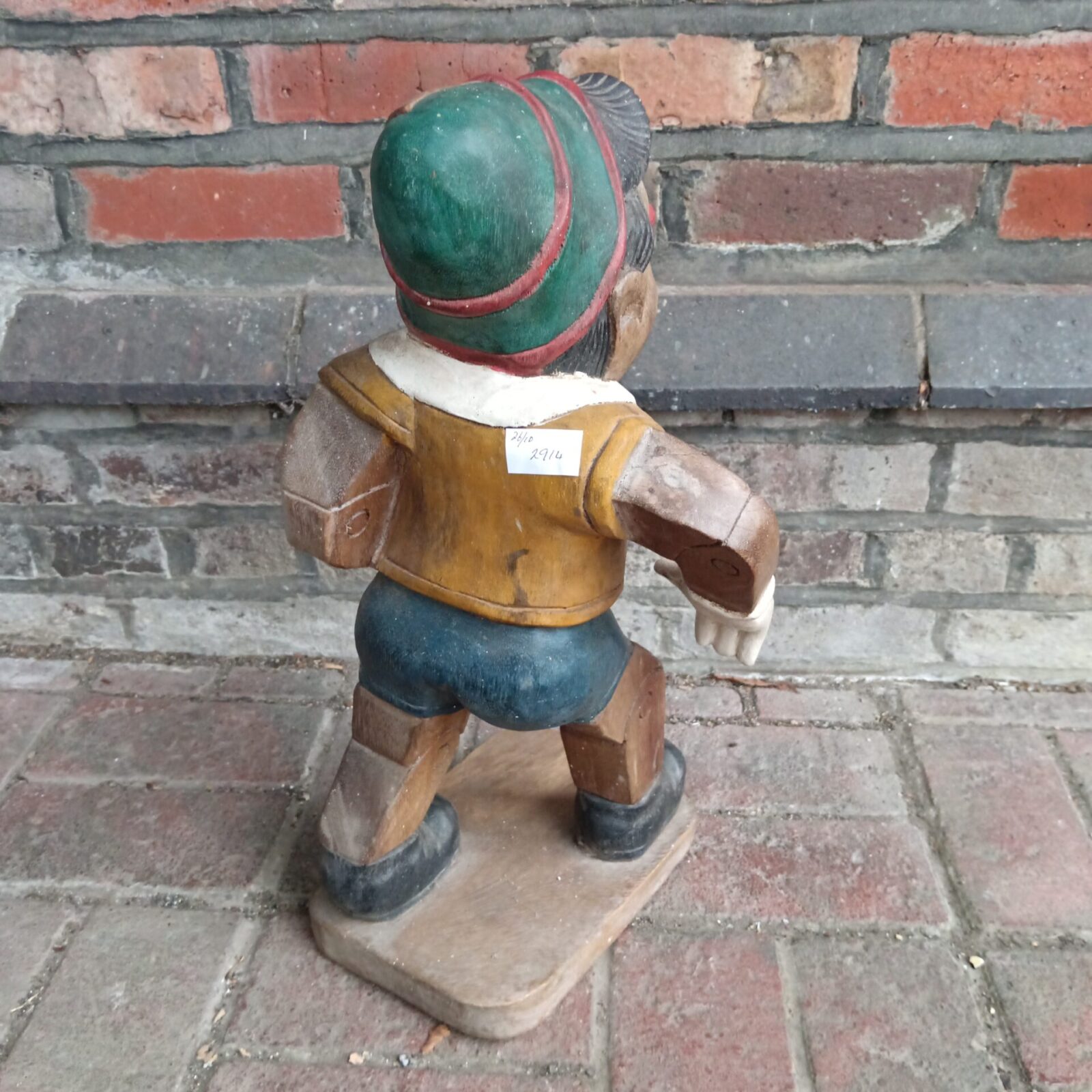 Close-up of vintage hand-carved Pinocchio statue, folk art detail.