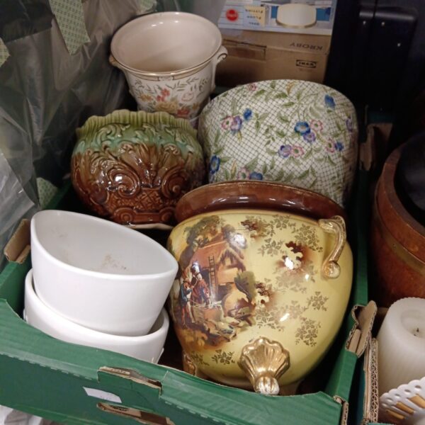 Collection of vintage ceramic plant pots with floral designs.