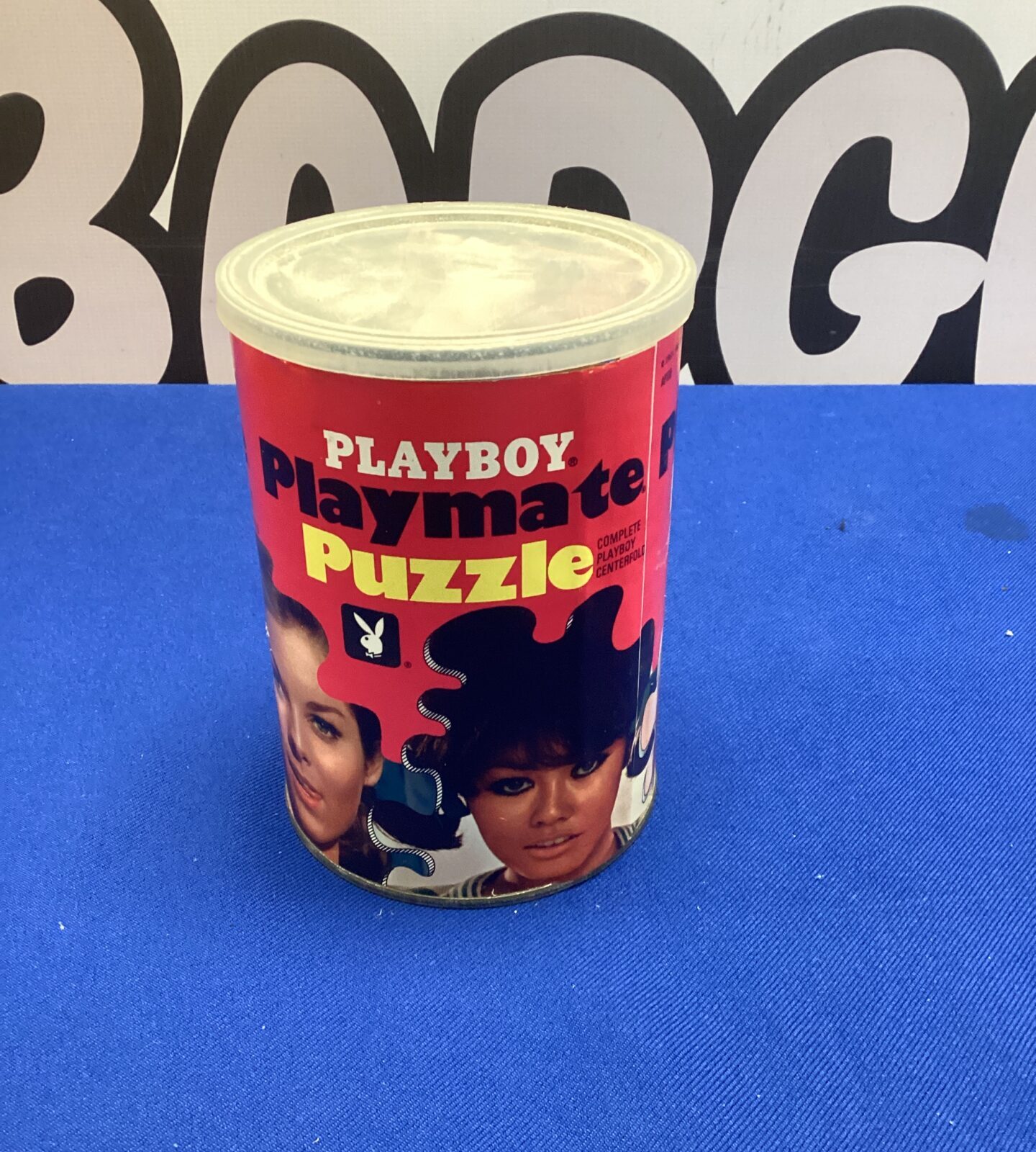 Vintage tin puzzle featuring the Playboy logo and playmate image.