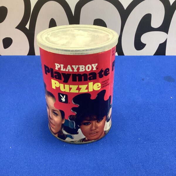 Vintage tin puzzle featuring the Playboy logo and playmate image.