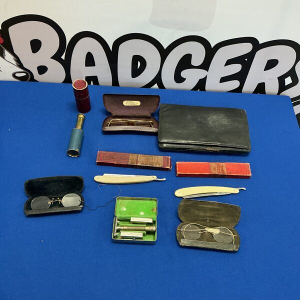 Vintage razor collection with various styles and grooming tools.