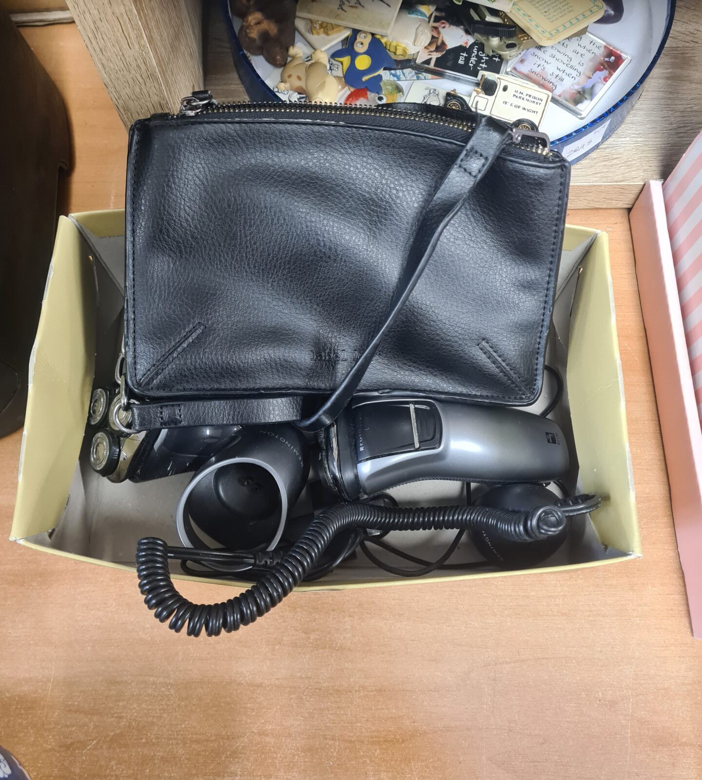 Vintage Remington electric shaver with coiled cord.