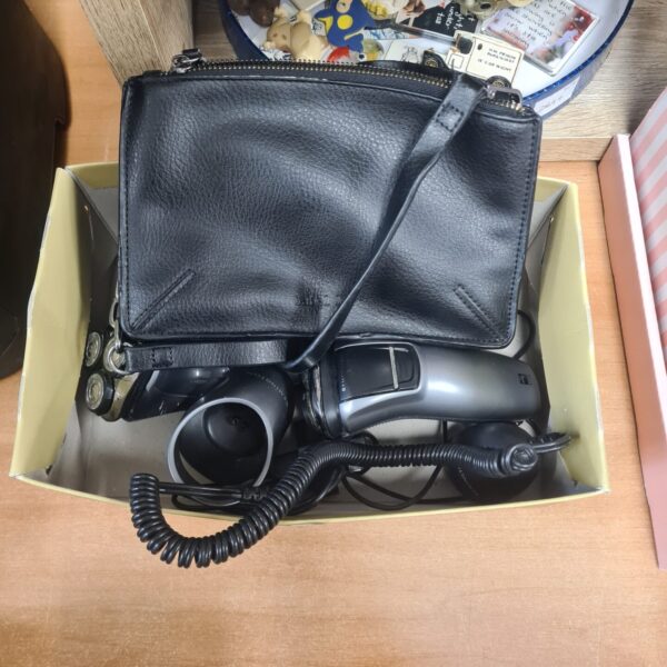 Vintage Remington electric shaver with coiled cord.