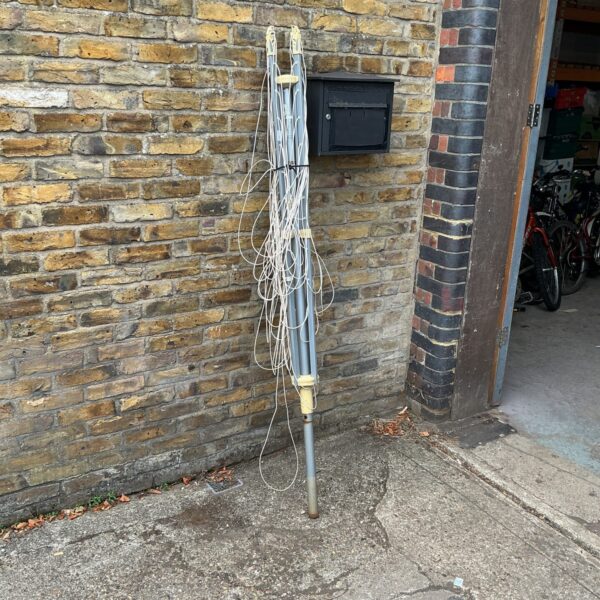 Vintage rotating clothes airer in a garden setting.