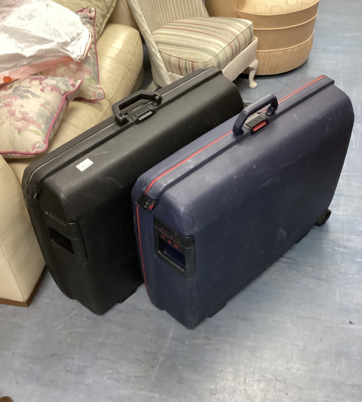 Two large vintage Samsonite suitcases with black and navy shells.