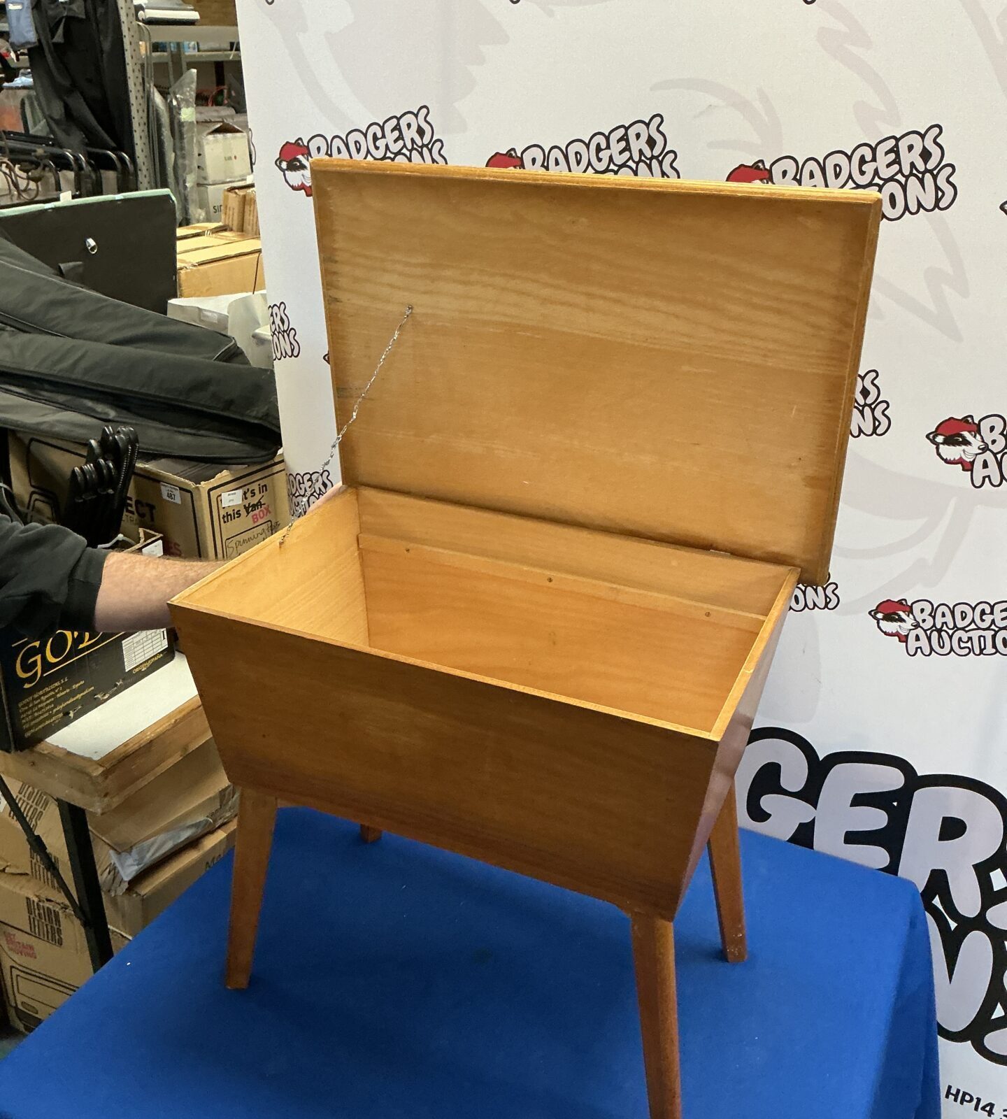 Close-up of vintage wooden sewing box with turned legs.