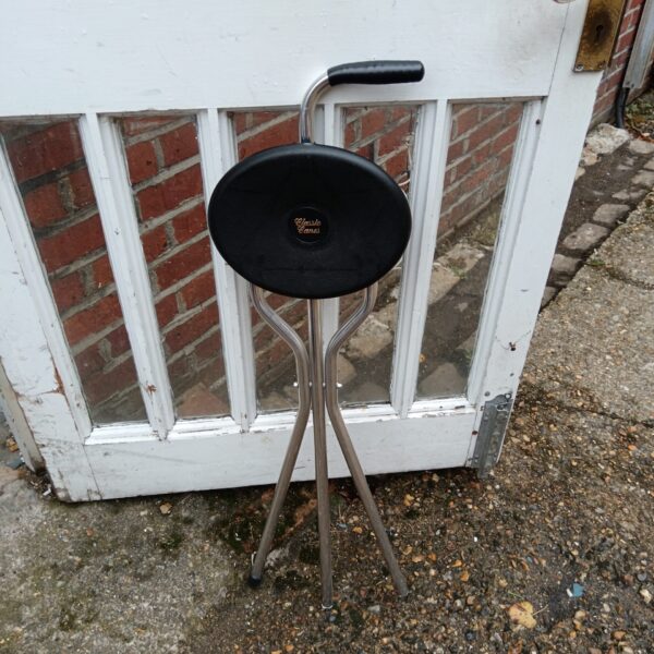 Vintage shooting stick with tripod base for game shooting.