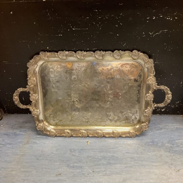 Ornate vintage silverplated tray with intricate detailing.