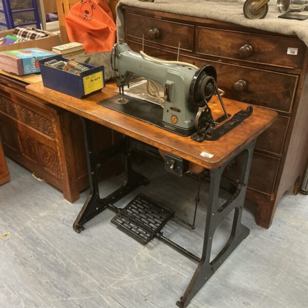 Vintage Singer 331k1 sewing machine with bobbins, retro home appliance.