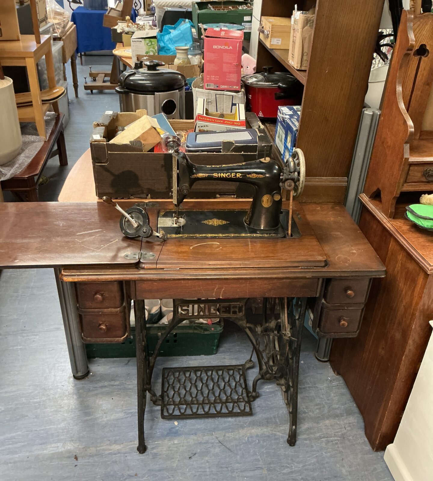Side view of a vintage Singer sewing machine table with drawers.