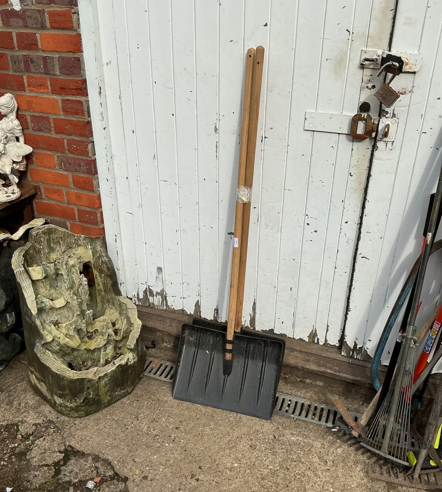 Vintage snow shovels lot with wooden handles and metal blades.