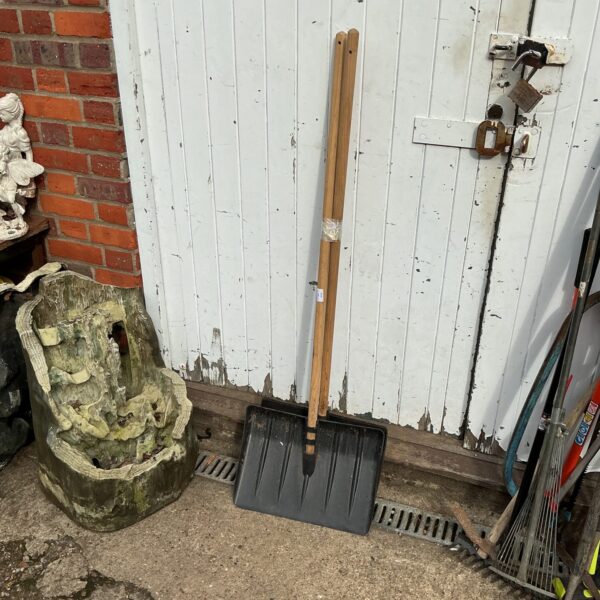 Vintage snow shovels lot with wooden handles and metal blades.