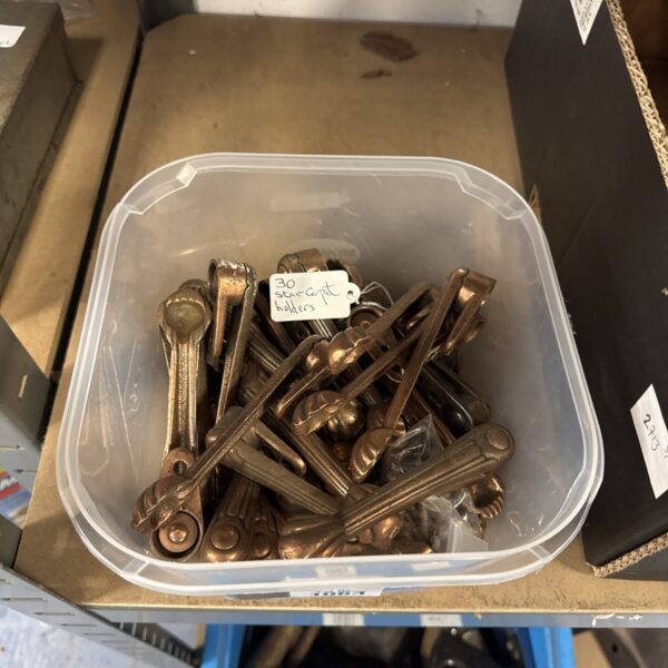 Box of approximately 30 vintage stair carpet holders for home restoration.