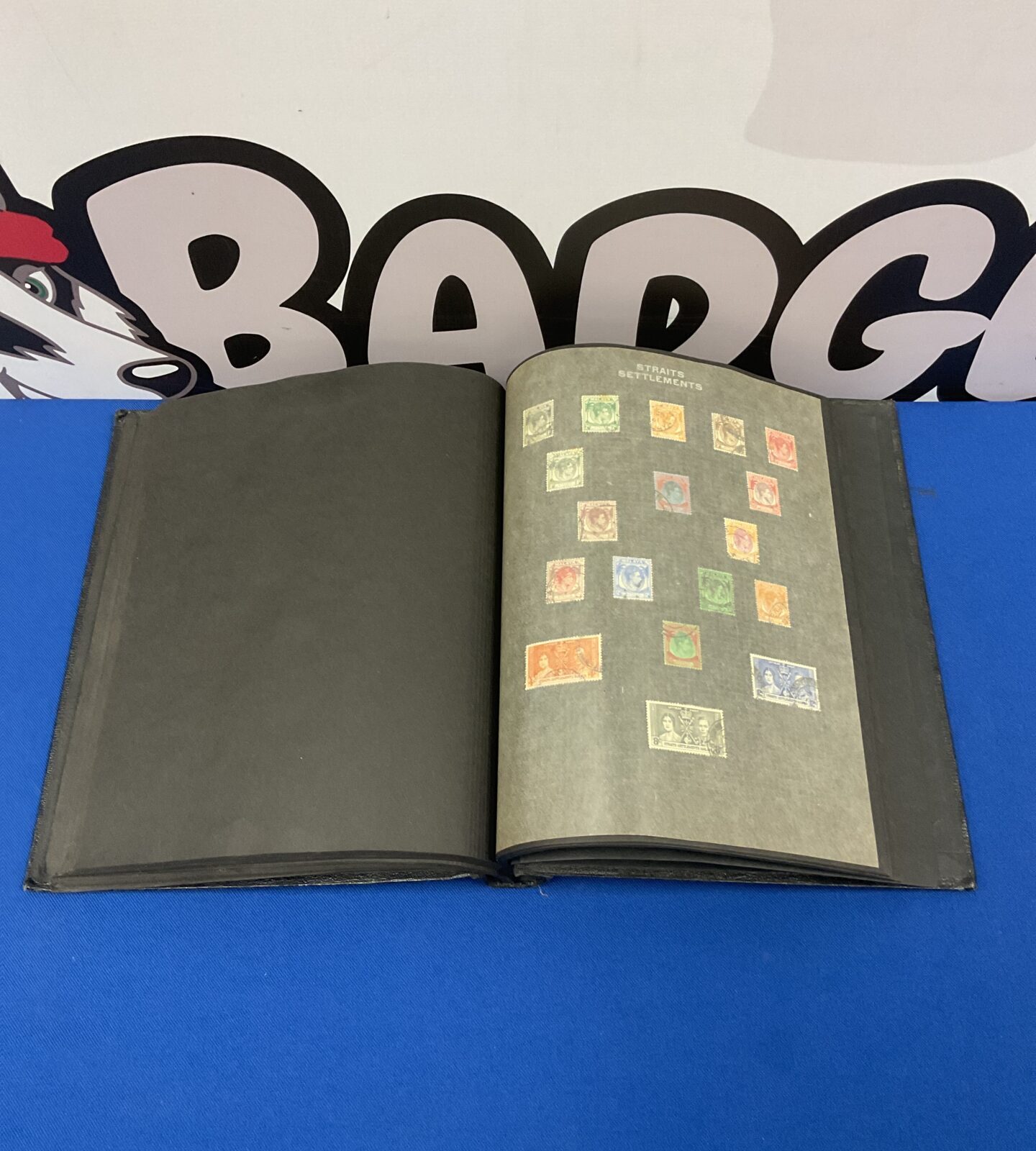 Closed vintage stamp album with a black cover.