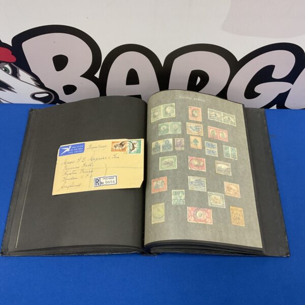 Open vintage stamp album displaying mounted world stamps.