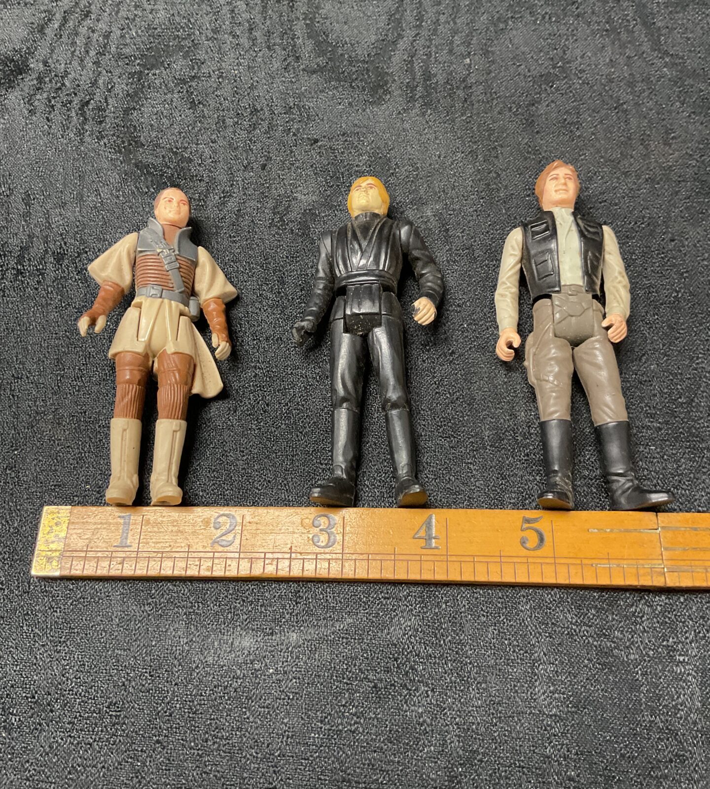 Vintage Star Wars action figures featuring Luke Skywalker, Han Solo, and Princess Leia.