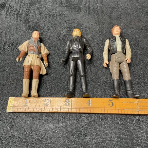 Vintage Star Wars action figures featuring Luke Skywalker, Han Solo, and Princess Leia.