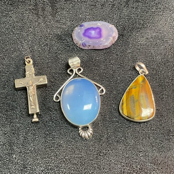Vintage stone pendants lot including crucifix, blue agate, and yellow agate.