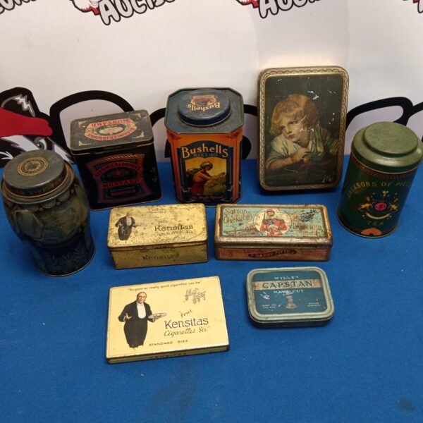 Vintage tin collection featuring Bushells tea and Dandy Fifth cigarette tins.