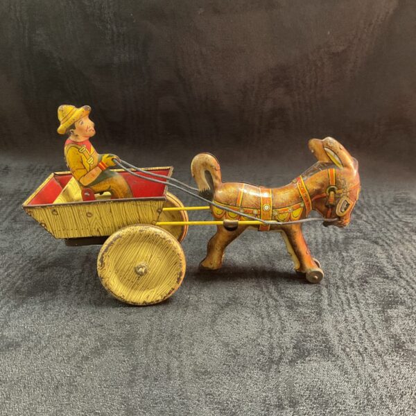 Side view of vintage tin litho Balky Mule toy with cart.