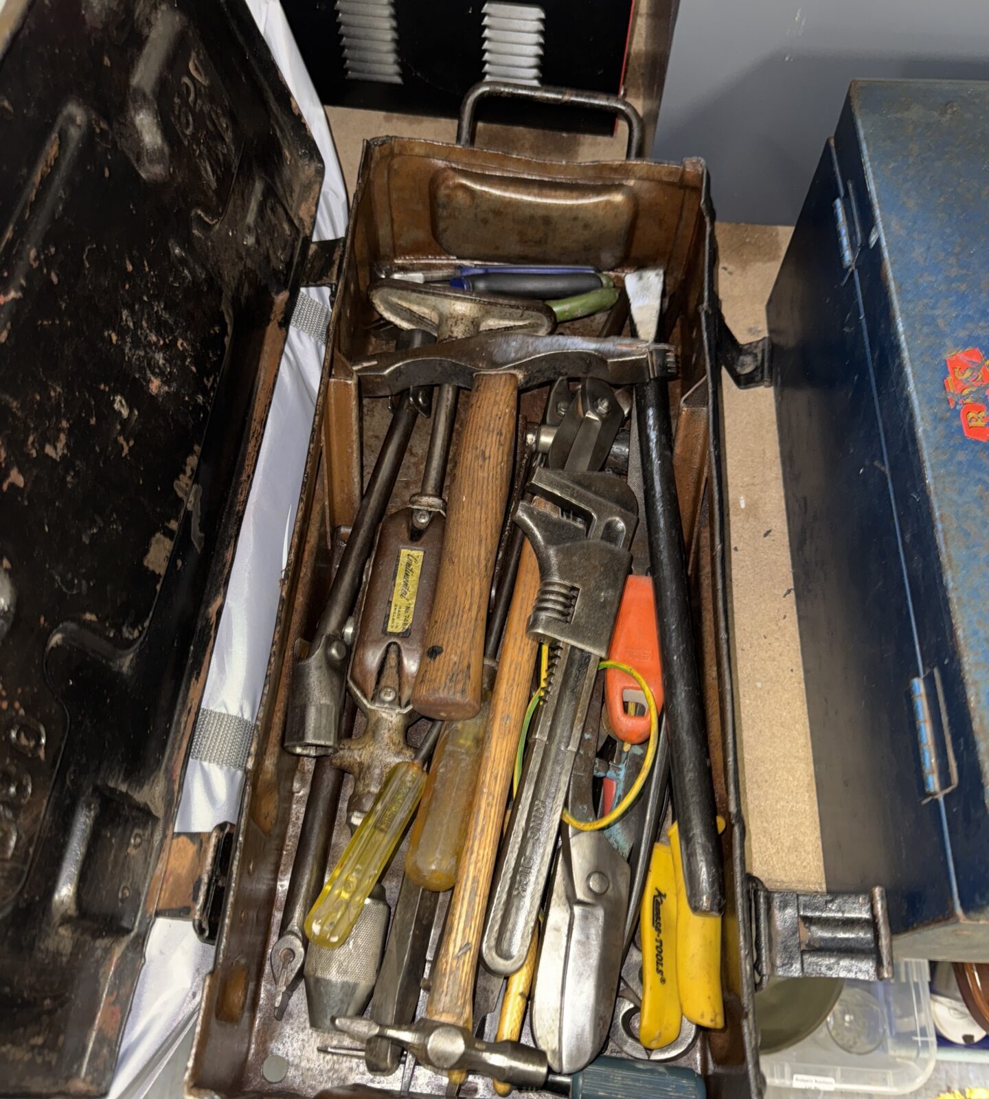 Vintage tool lot inside a military ammunition crate, antique hand tools.