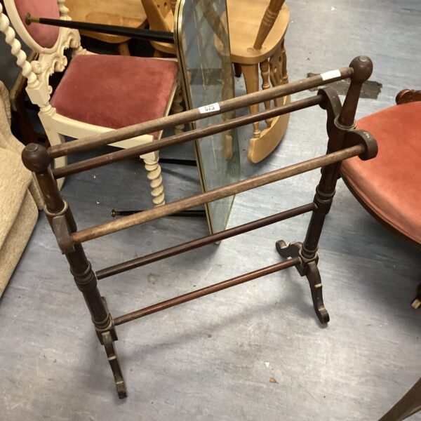 Vintage cast iron towel rail with decorative detailing.