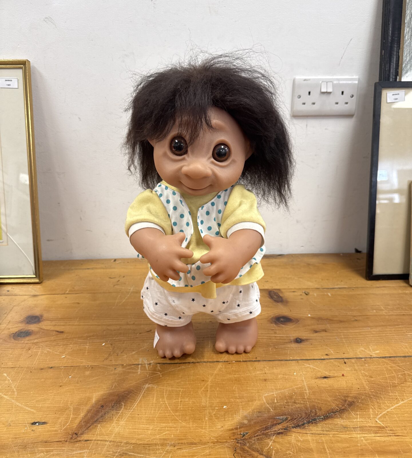 Vintage 1979 Troll doll with orange hair and yellow outfit.