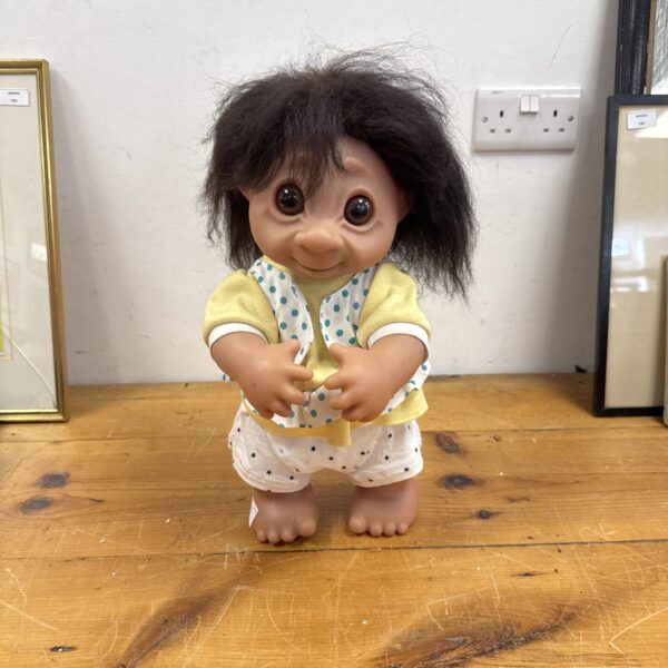 Vintage 1979 Troll doll with orange hair and yellow outfit.