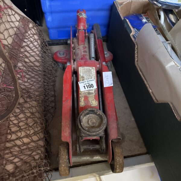 Vintage trolley jack for car maintenance and restoration.